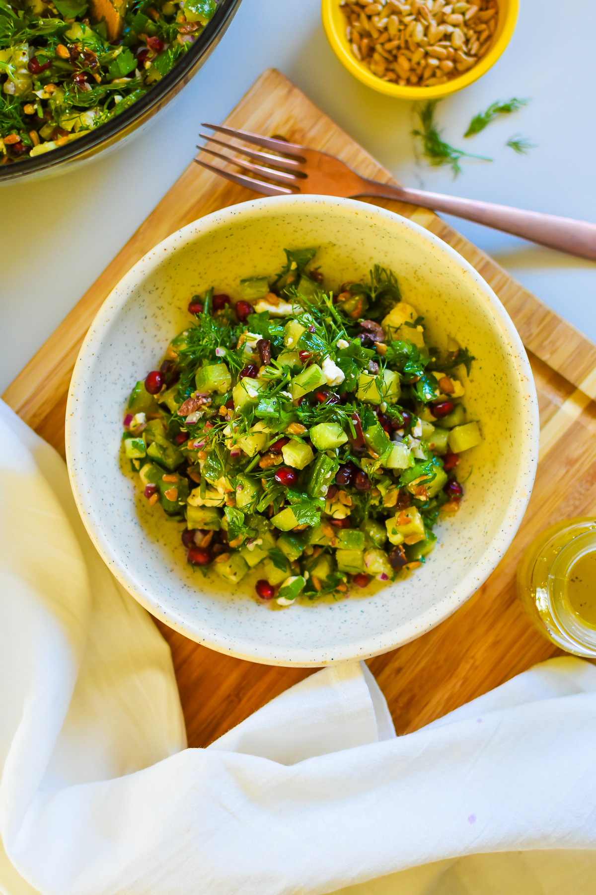 the best Mediterranean cucumber salad made with fresh, finely chopped ingredients served in a stone bowl with simple apple cider vinegar dressing.