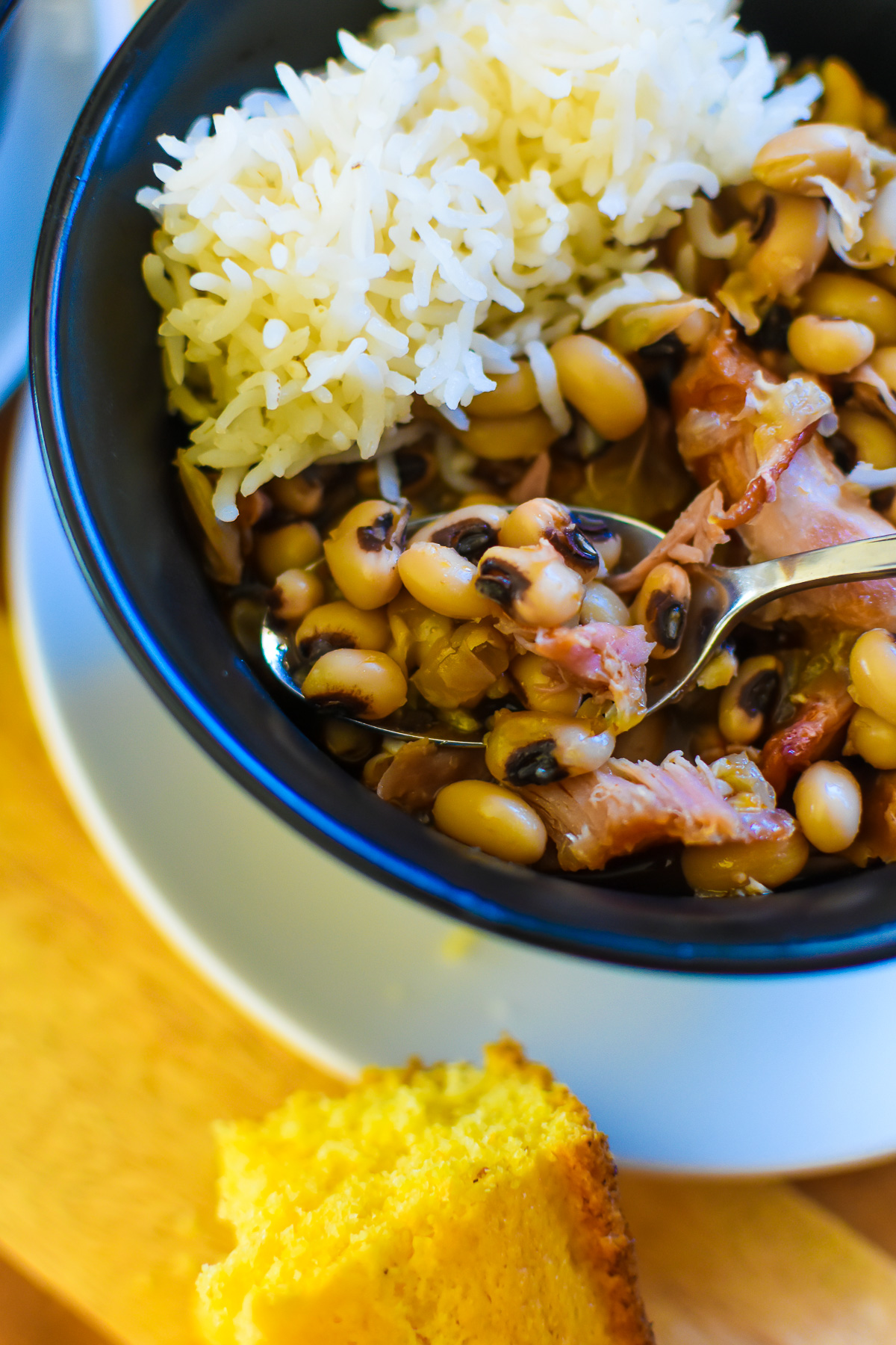 spoonful of plump and flavorful black eyed peas in bowl.
