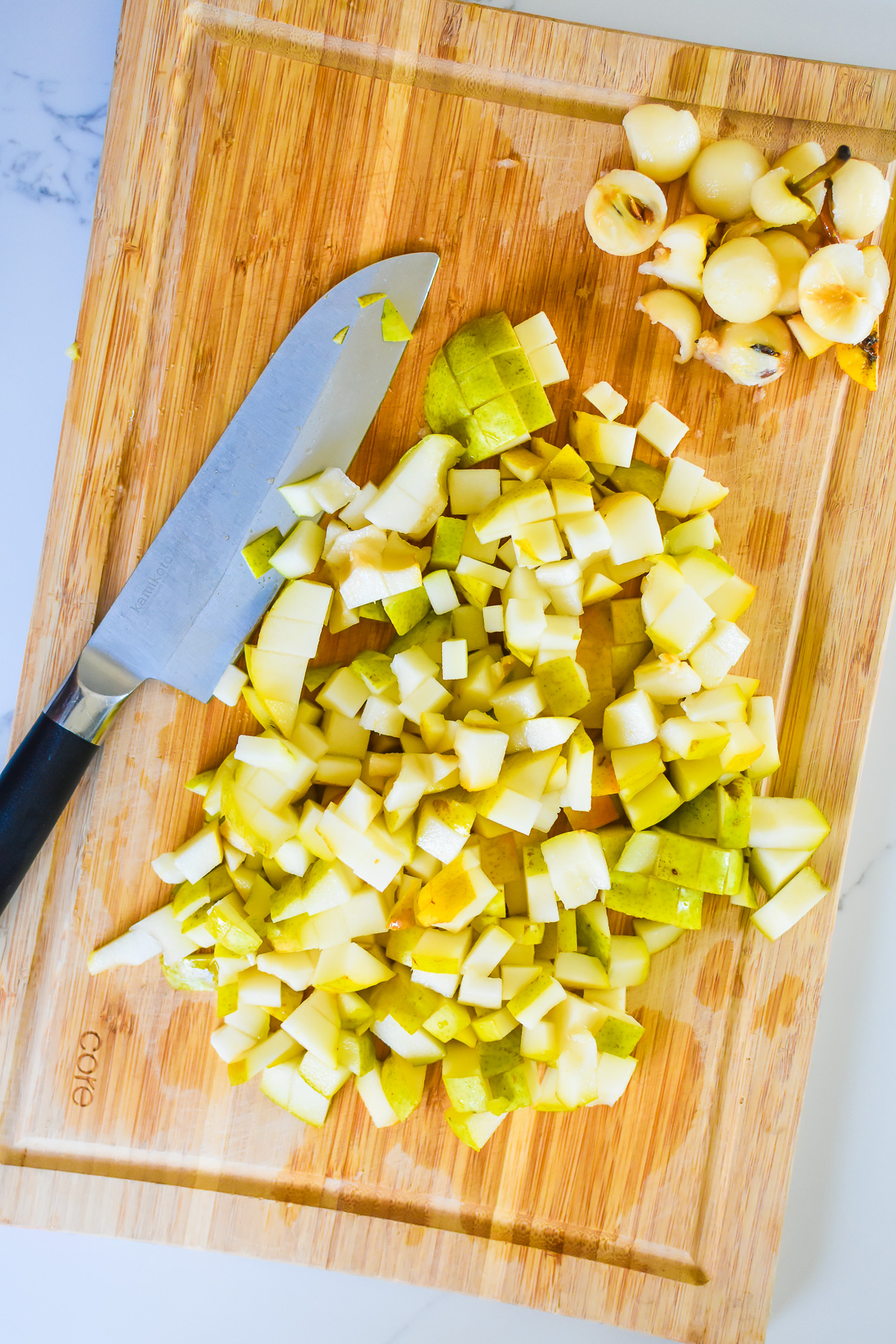 diced bartlett pears on wooden cutting board.