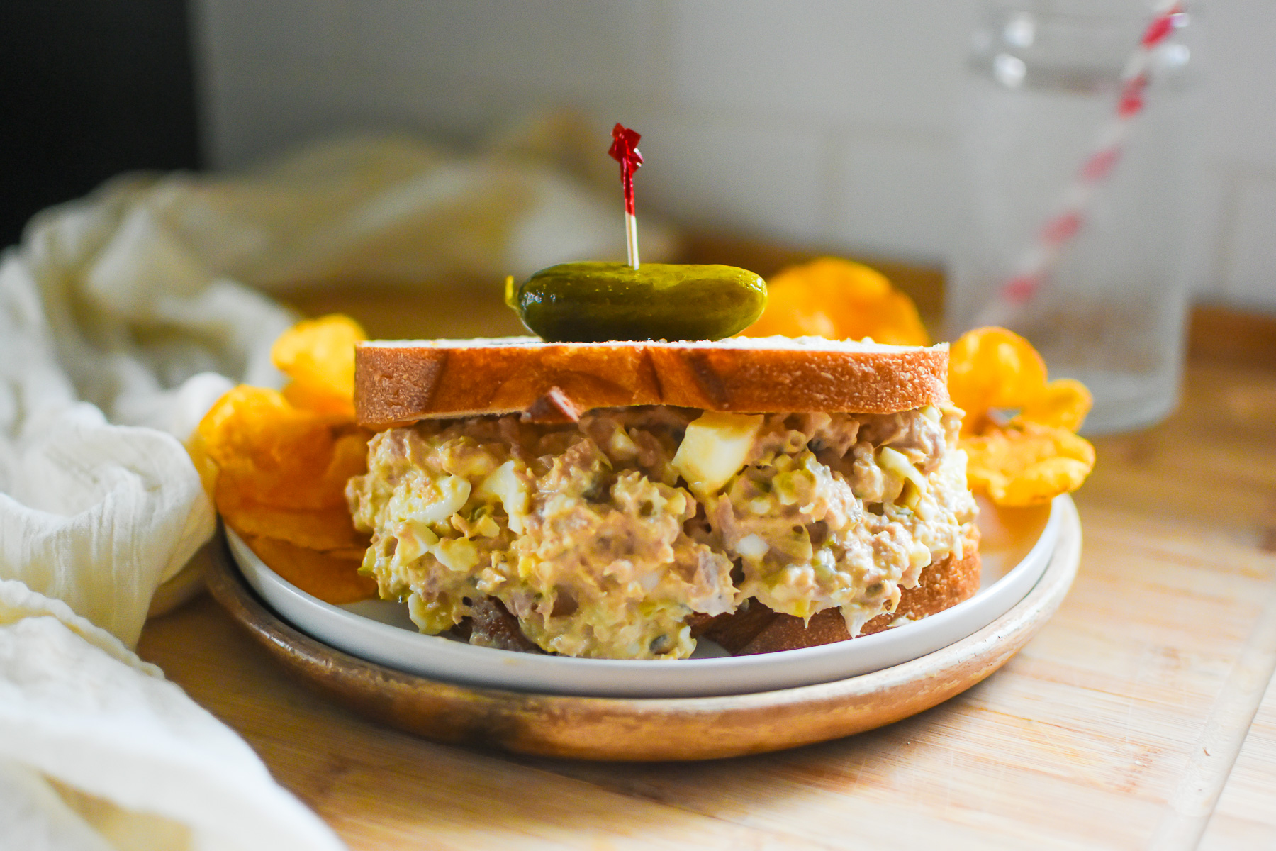southern tuna fish sandwich served on sandwich bread with Voodoo chips and pickles.