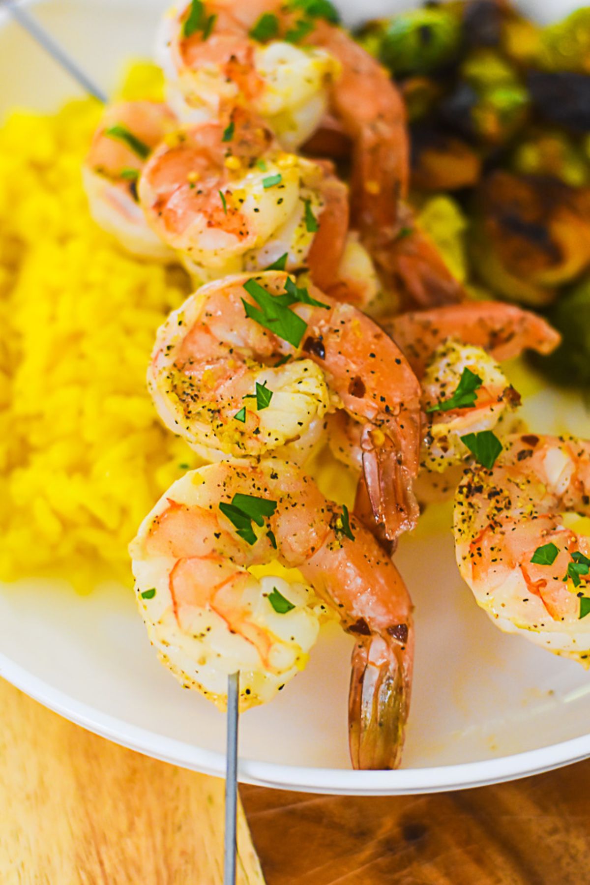 quick and easy skewers of lemon pepper shrimp served with yellow rice and brussels sprouts.