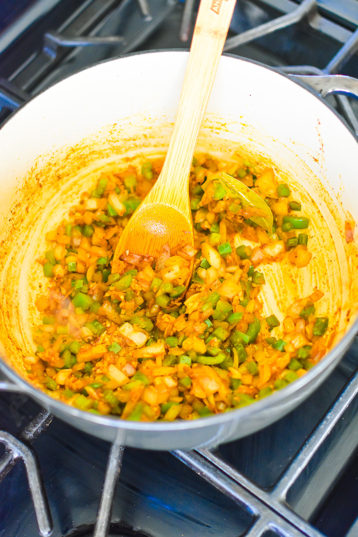 onion, pepper, garlic, and spices cooking in ground beef drippings.