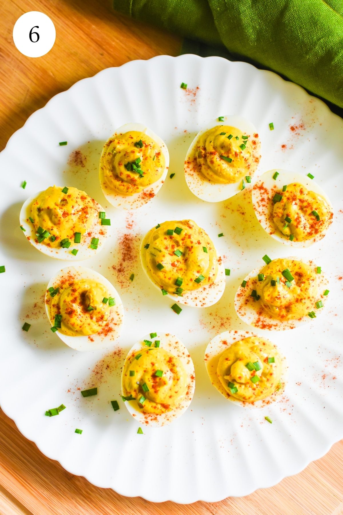 African American southern deviled eggs served on a scalloped white plate.