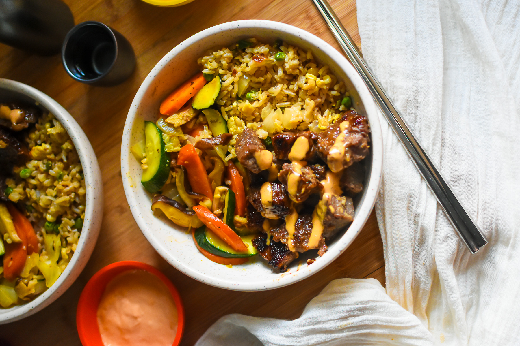 DIY hibachi bowl with steak, vegetables, egg fried rice, and yum yum dipping sauce.
