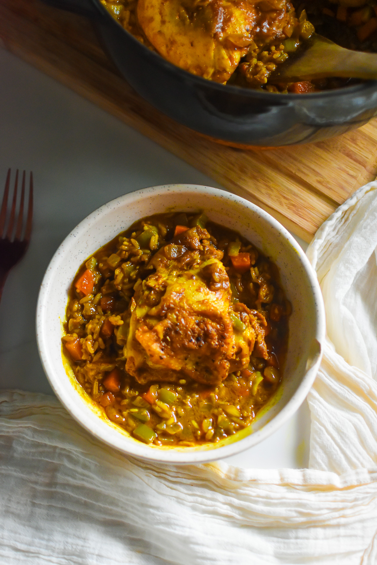 easy curry chicken and rice made with coconut milk served in a stone bowl.