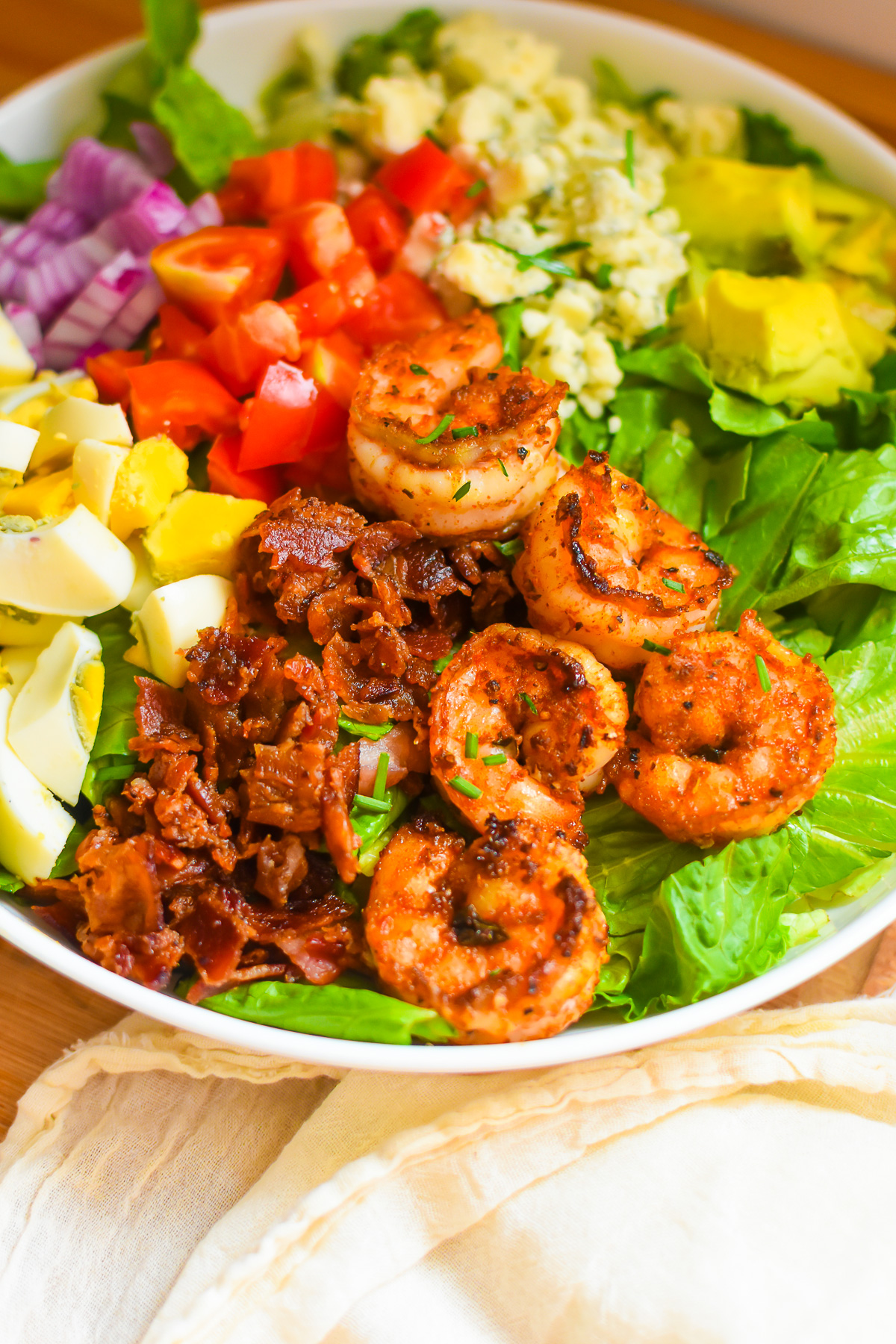 colorful cobb salad made at home with juicy blackened shrimp on top.