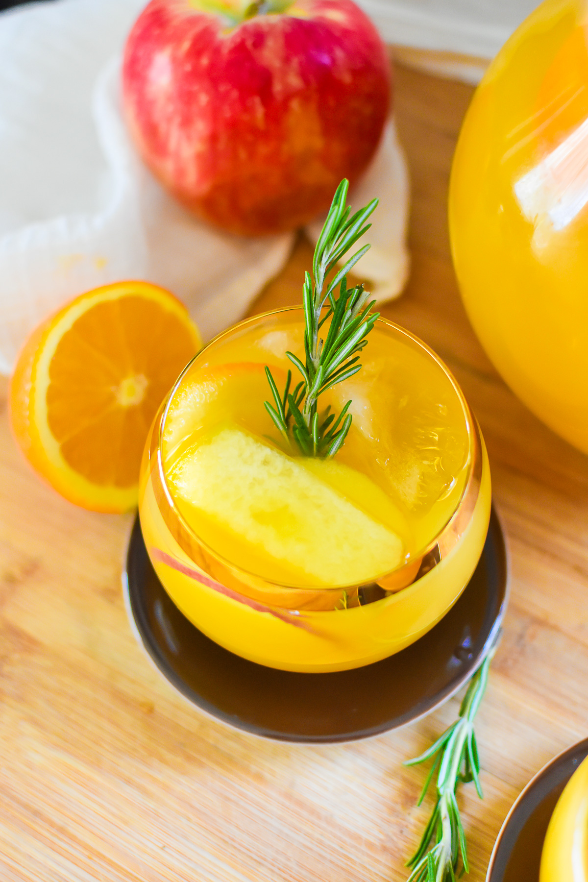 Thanksgiving sparkling punch for a crowd served in a gold rimmed globe-shaped glass.